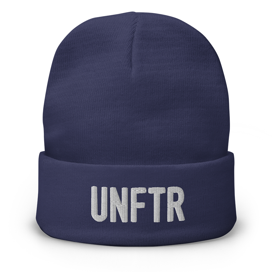 Navy cuffed beanie with white embroidered logo that says ‘UNFTR
