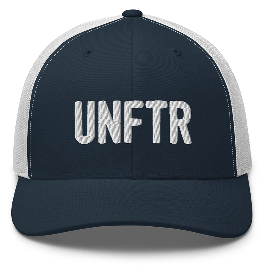 Navy trucker hat with white panels and white embroidery that says UNFTR