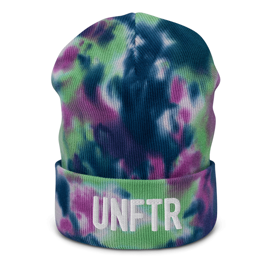 Navy, green, purple and white beanie with embroidered white logo that says UNFTR