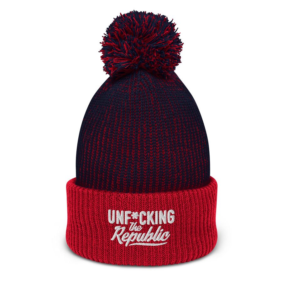 Speckled navy and red pom-pom beanie with white embroidered logo that says ‘Unf_cking The Republic’_