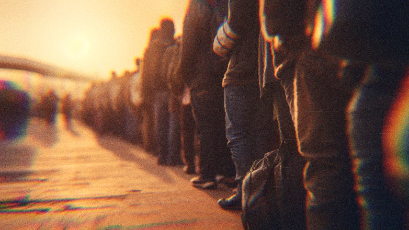 A group of migrants lined up at the border.