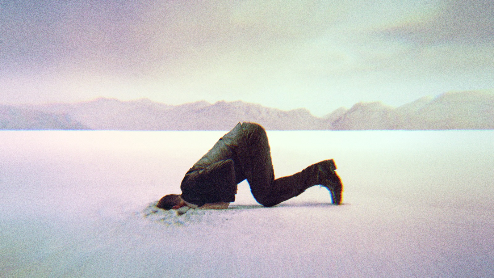 A man putting his head in the sand.