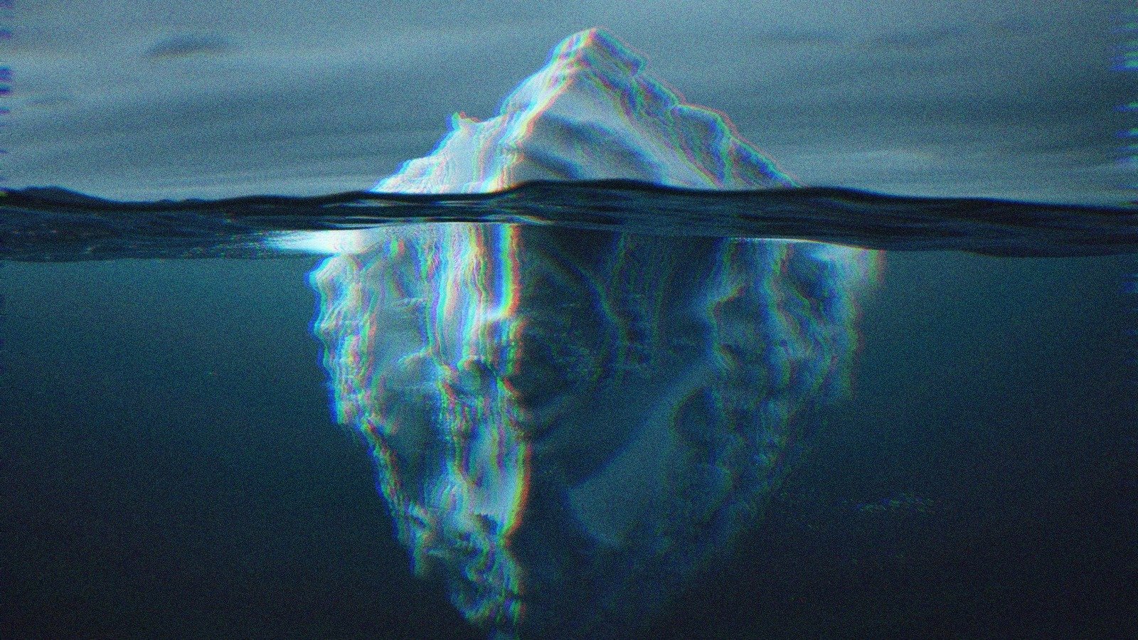 An iceberg visible above and below the water.