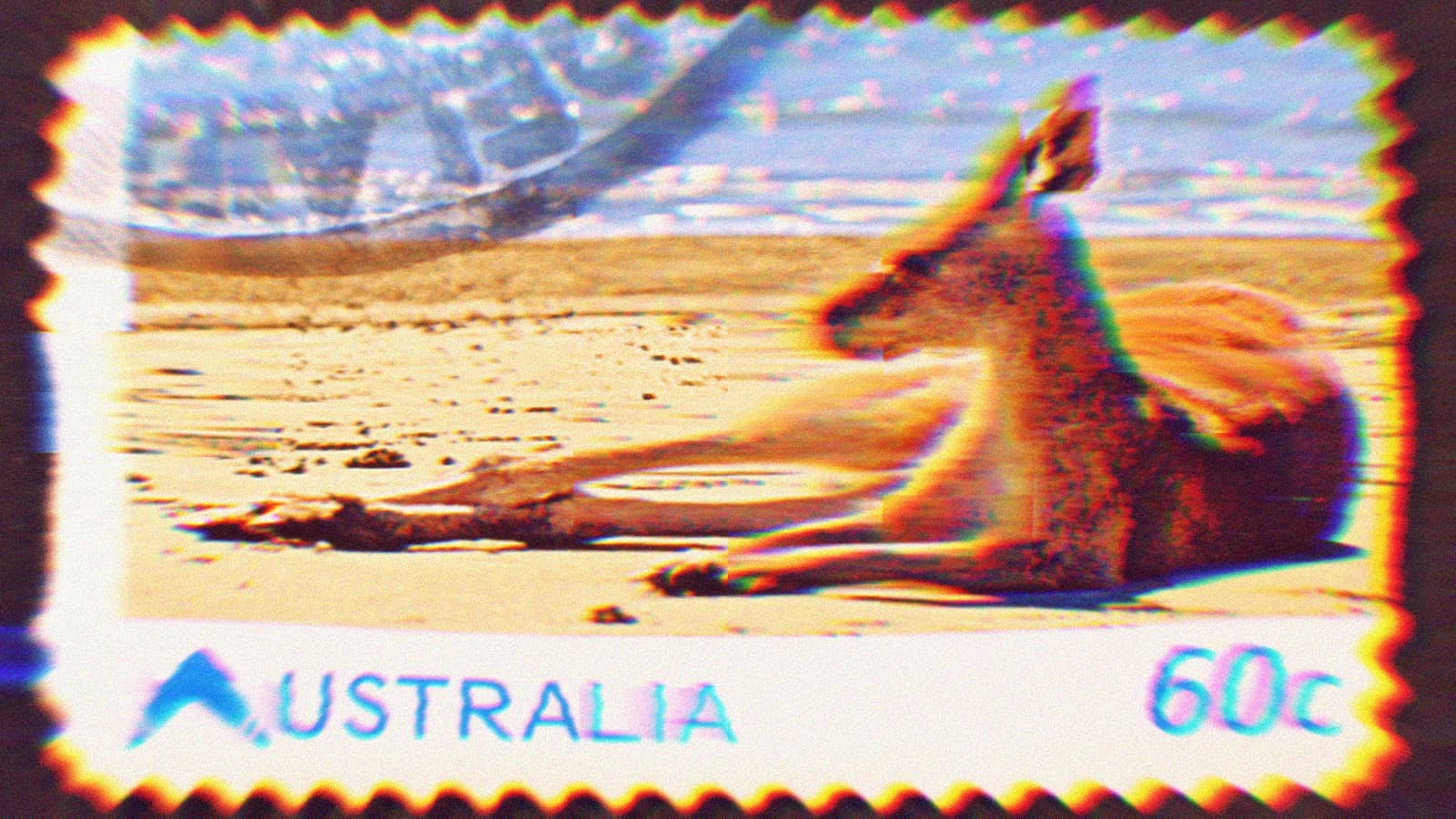 Australian 60c postage stamp depicting a kangaroo laying on the beach.