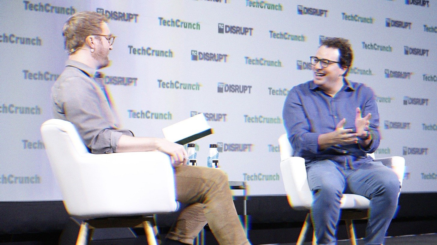 Dario Amodei speaking on stage to a moderator at TechCrunch Disrupt in 2023.