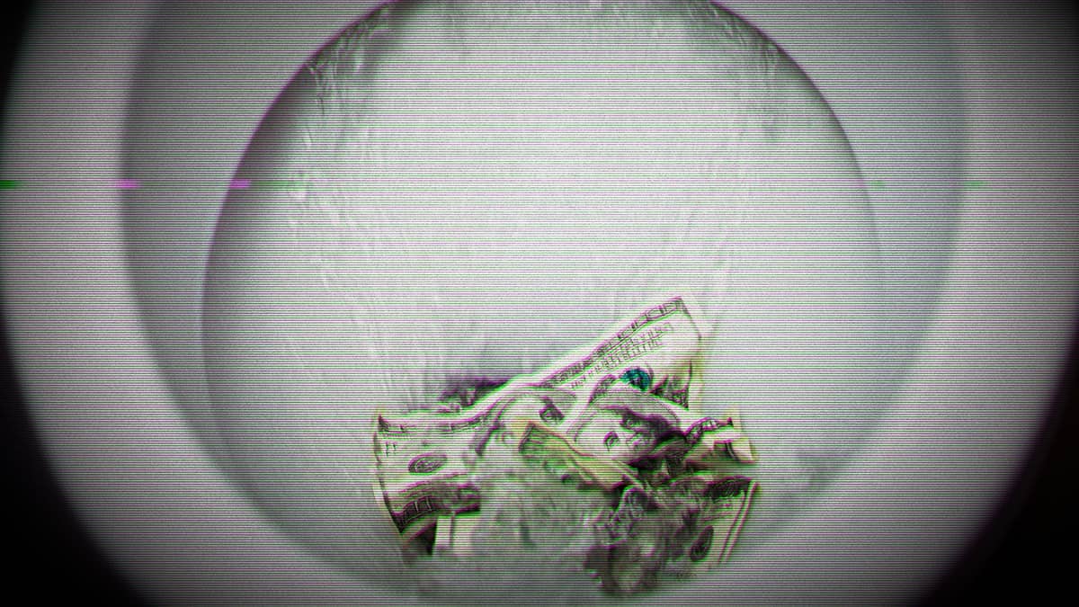 Money being flushed down the toilet.