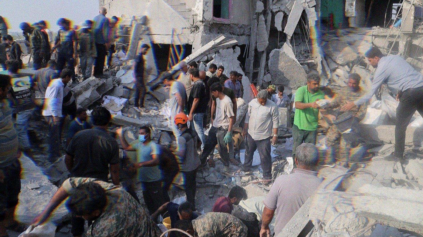 People clearing the rubble after the Shajarah Tayyebeh attack.