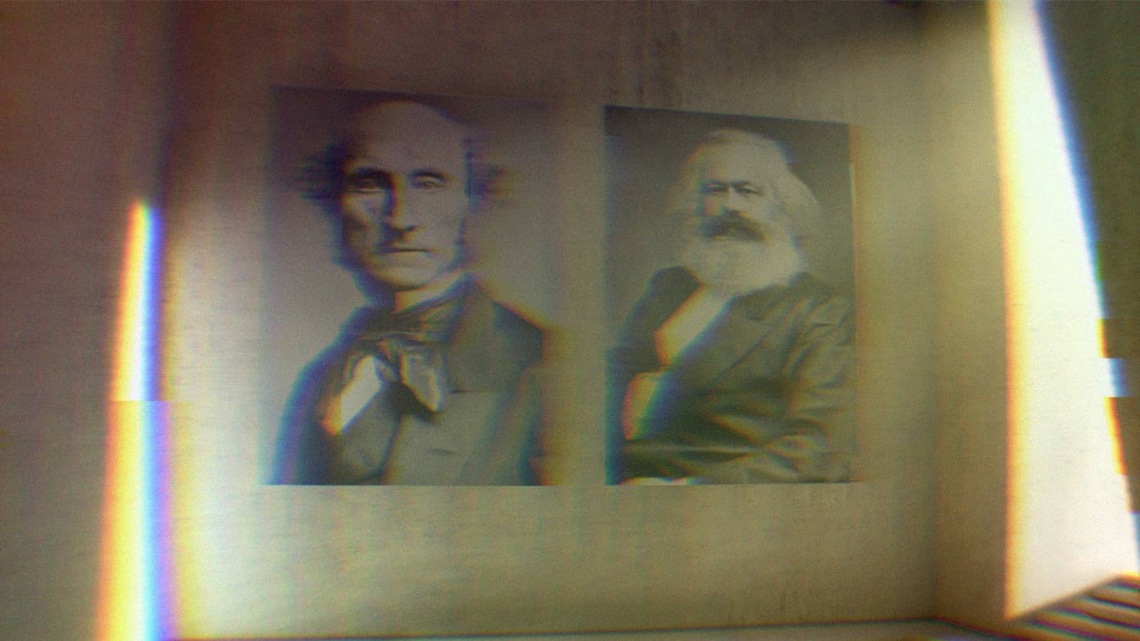 Portraits of Karl Marx and John Stuart Mill in a gallery.