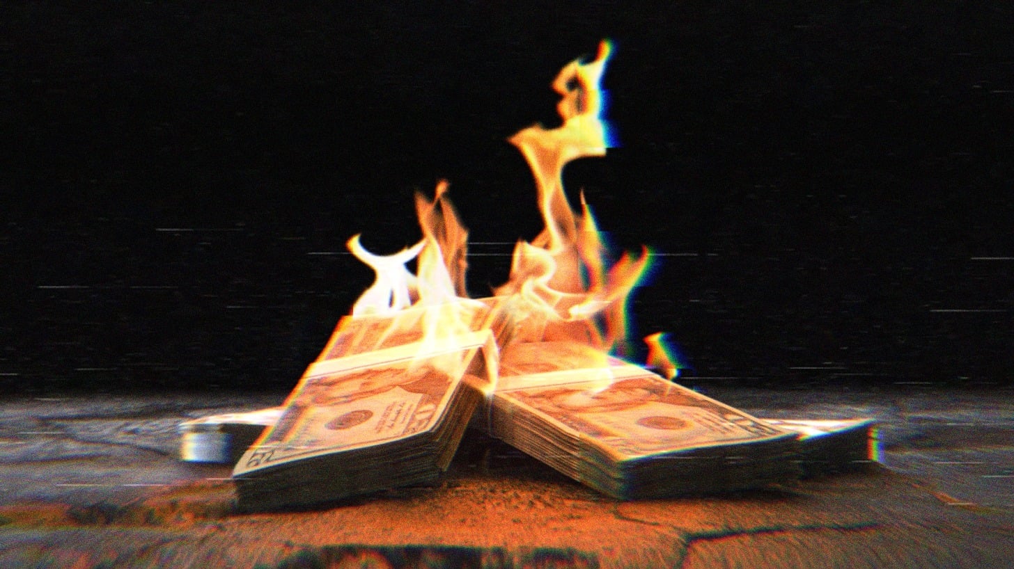 Stacks of $20 bills on fire.
