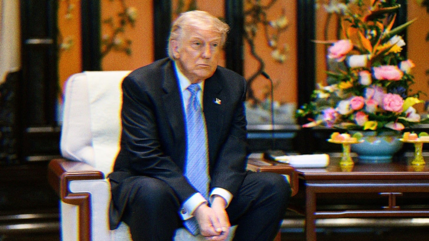 Trump sitting in a chair, looking bored.